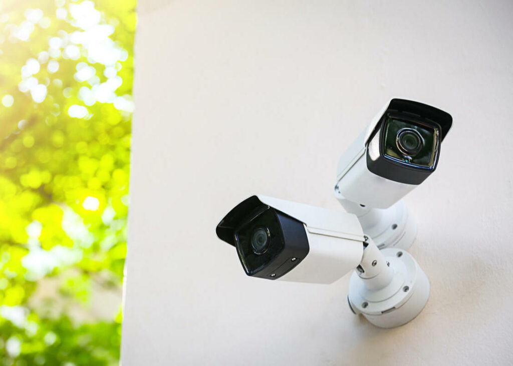 Outdoor CCTV monitoring, security cameras with sunlight flare.